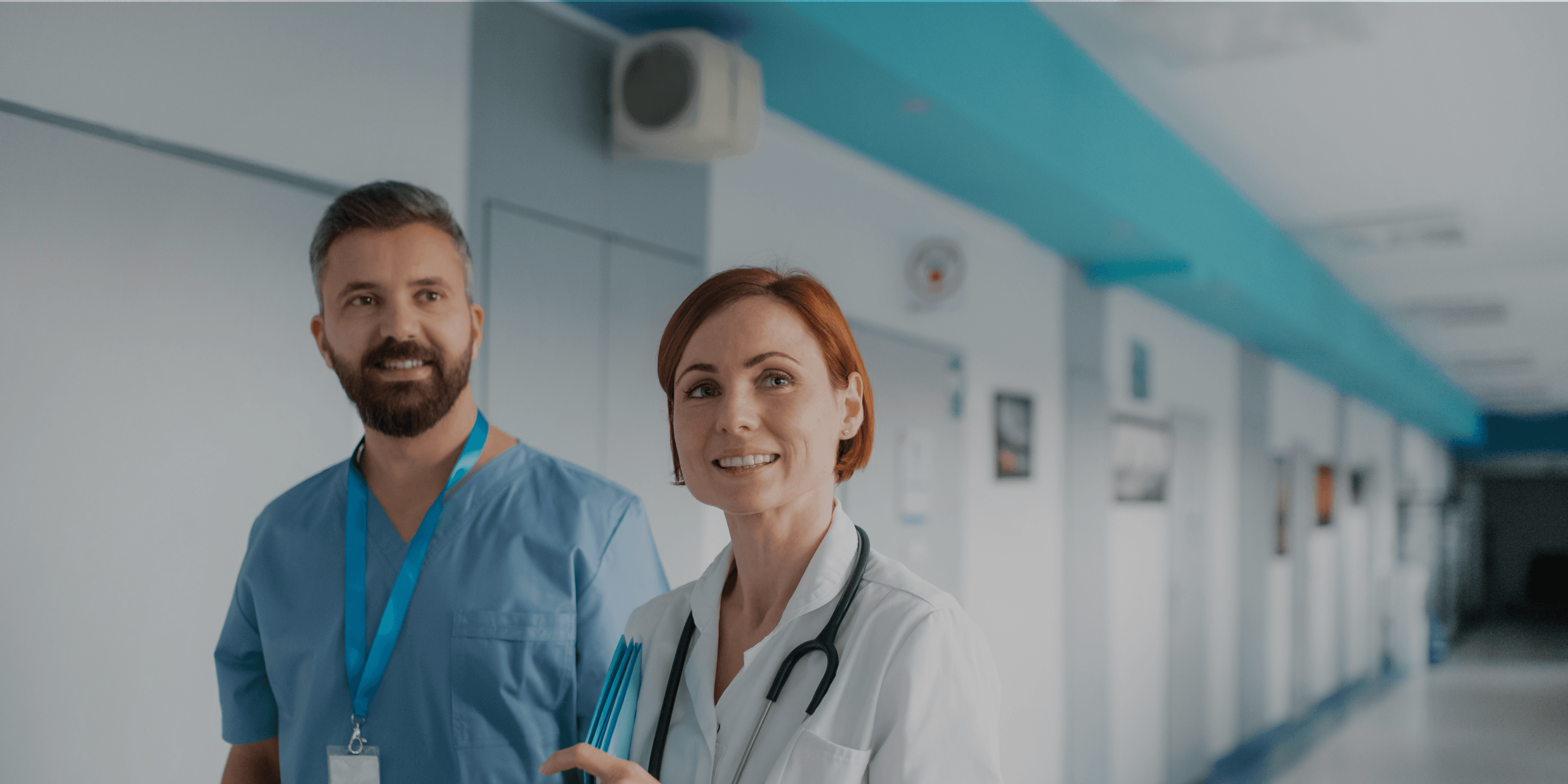 Twee ziekenhuismedewerkers lopend in de gang